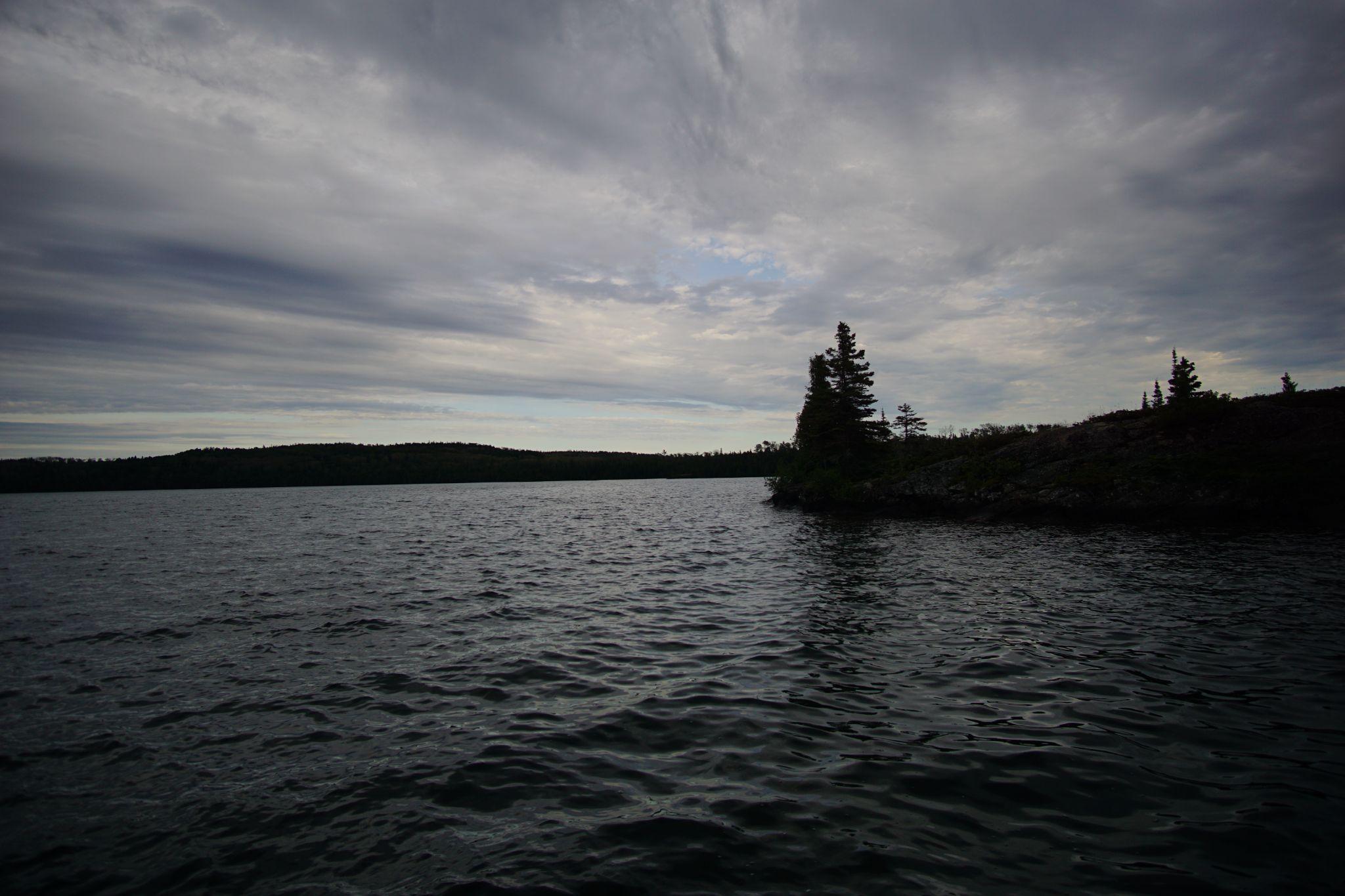 Clouds streaked and water darkened.